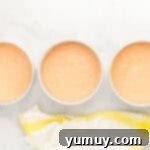 Vibrant Strawberry Lemon Cake 9 peach colored cake batter divided between three round cake pans.