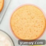 Vibrant Strawberry Lemon Cake 10 a leveled layer of pink lemonade cake on a cake stand.