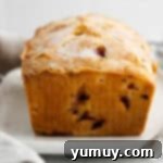 side view of strawberry rhubarb cake on a rectangular cake plate.