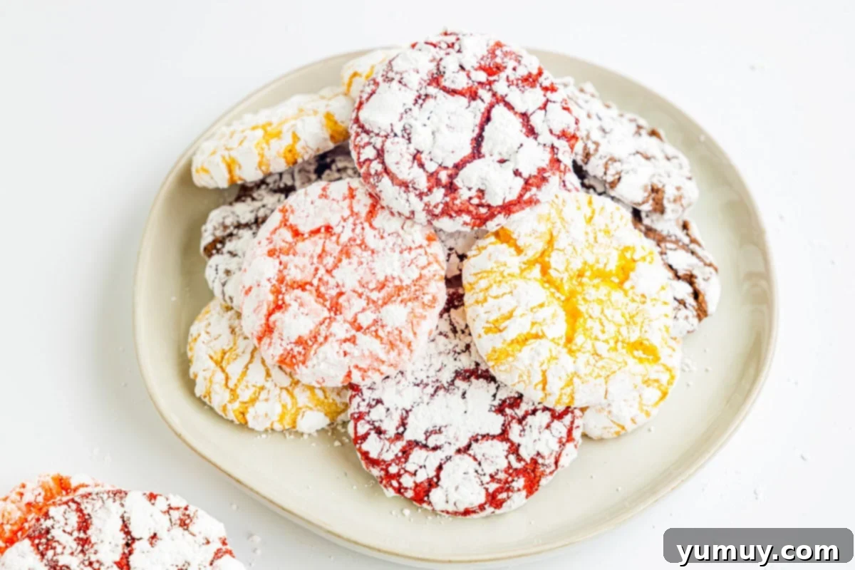 Cool Whip Cloud Cookies 12 Three-quarters view of stacked colorful Cool Whip cookies on a plate, showcasing their inviting texture and various flavors.