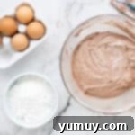 Cool Whip Cloud Cookies 6 chocolate cookie dough in a glass bowl next to a bowl of powdered sugar.