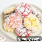 Cool Whip Cloud Cookies 8 three-quarters view of stacked colorful cool whip cookies on a plate.