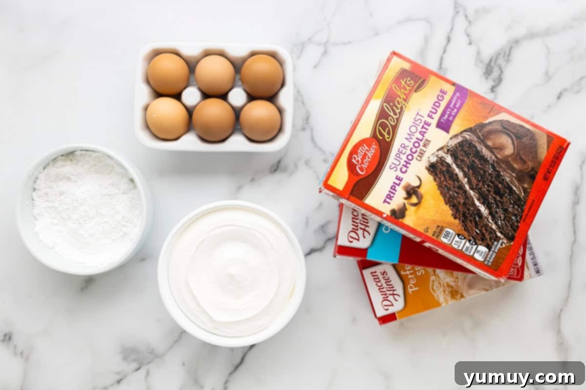 Cool Whip Cloud Cookies 9 Ingredients for Cool Whip cookies: a tub of Cool Whip, eggs, powdered sugar, and boxes of cake mix ready for preparation.