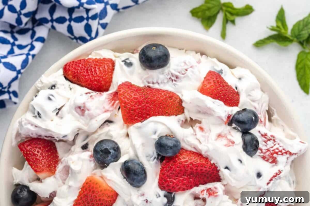 Last Hurrah of Summer Desserts 3 A vibrant berry cheesecake salad featuring fresh strawberries, blueberries, and a creamy cheesecake dressing, perfect for a Labor Day celebration.