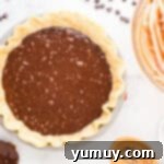 German Chocolate Coconut Pecan Delight Pie 12 German chocolate pie filling poured over a par-baked pie crust in a pie pan.