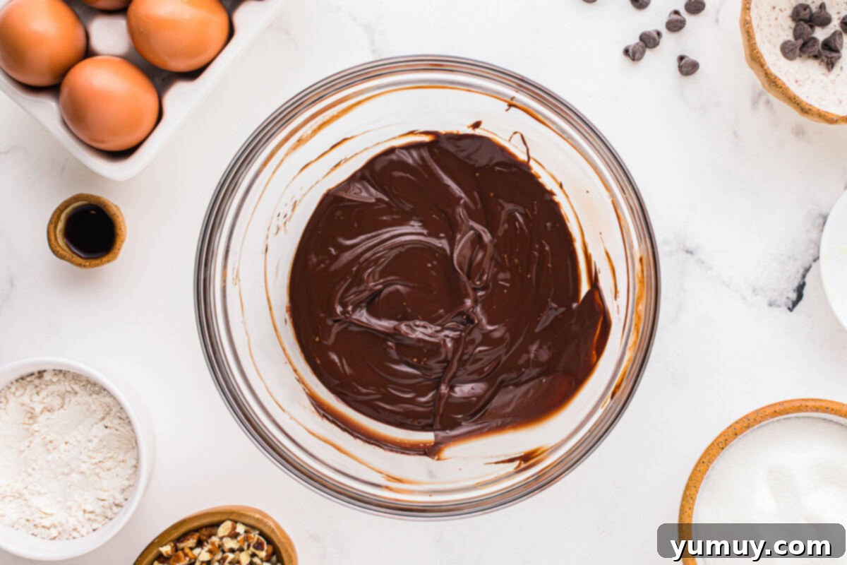 German Chocolate Coconut Pecan Delight Pie 18 A smooth, glossy pool of melted chocolate in a clear glass bowl, showcasing its rich, dark color.