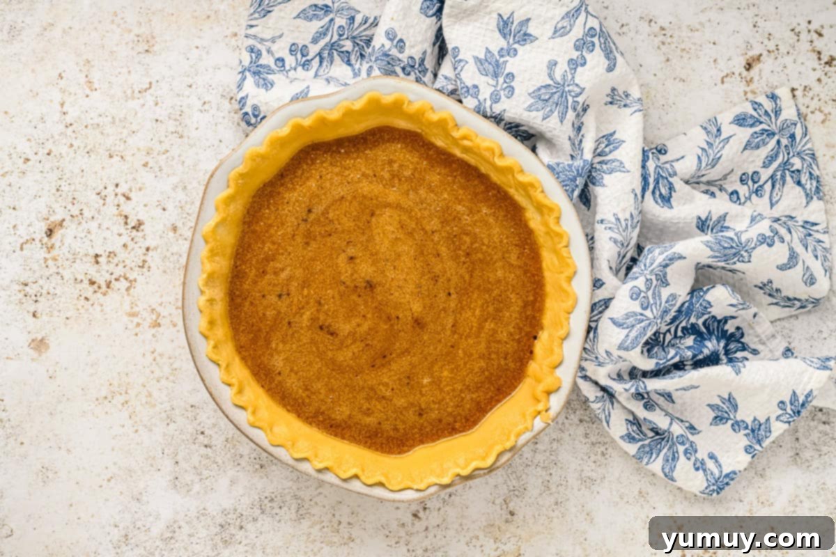 Vinegar Pie A Slice of Humble Pie: The Unexpected Delight 11 Vinegar pie filling being poured into a pre-baked pie crust, ready for the final bake.