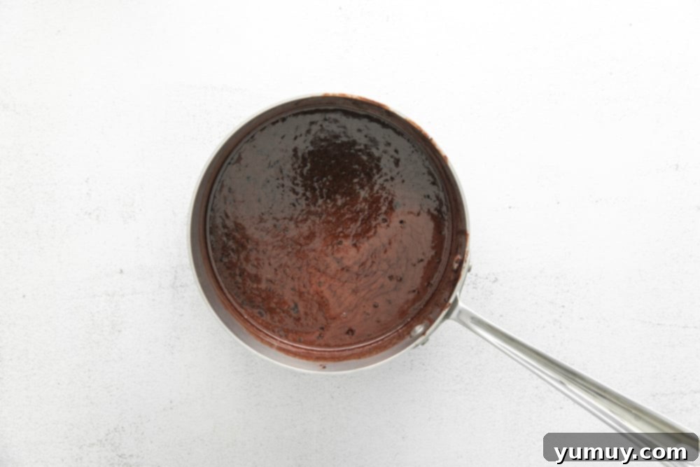 chocolate sauce in a spoon on a white background.