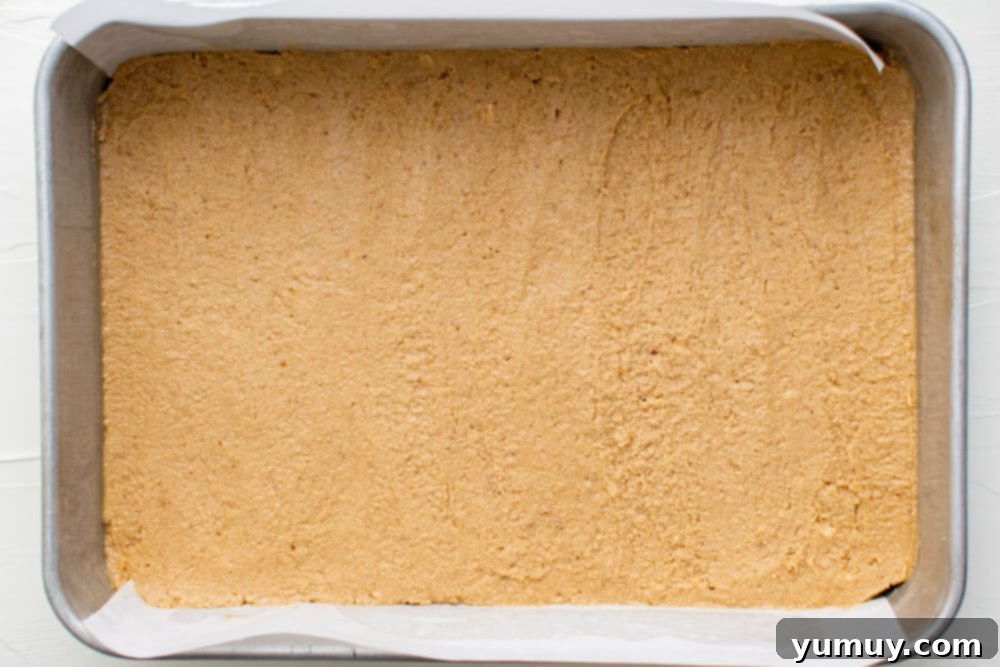 Peanut Butter Dream Bars 16 peanut butter spread into the bottom of a pan
