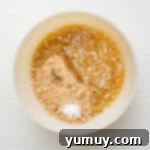 Peanut Butter Dream Bars 6 a white bowl with a mixture of flour and sugar.