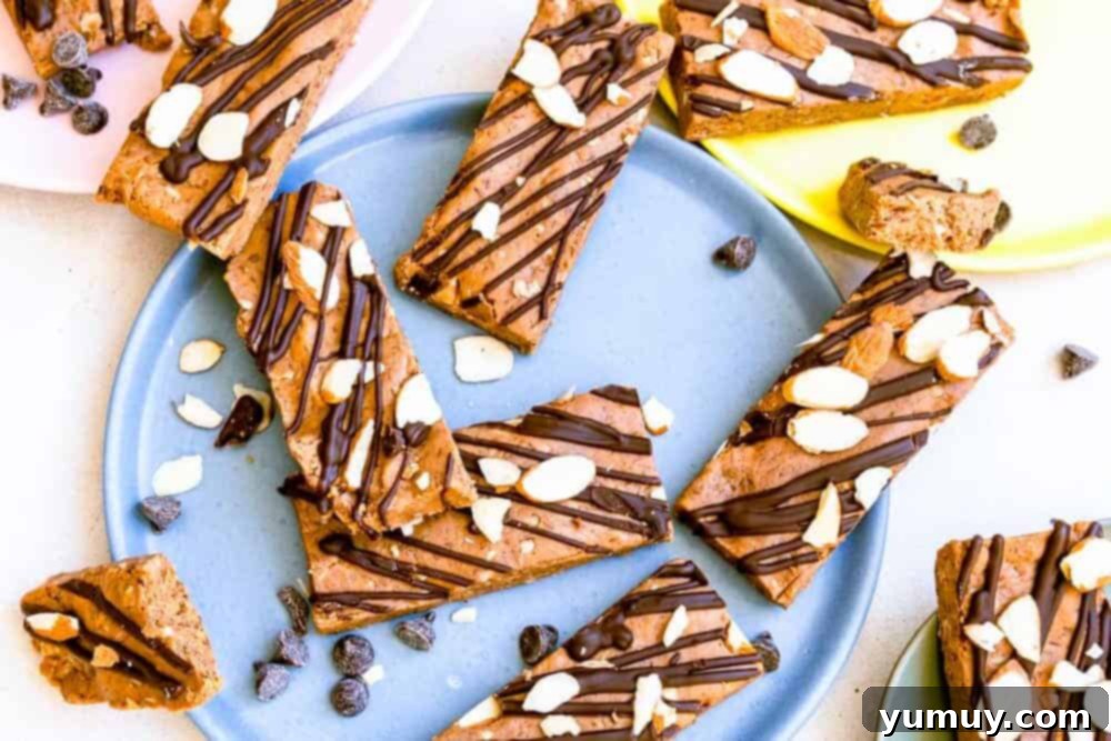 Crafting Your Perfect Protein Bars 3 healthy homemade protein bars scattered on a tablescape with colorful plates