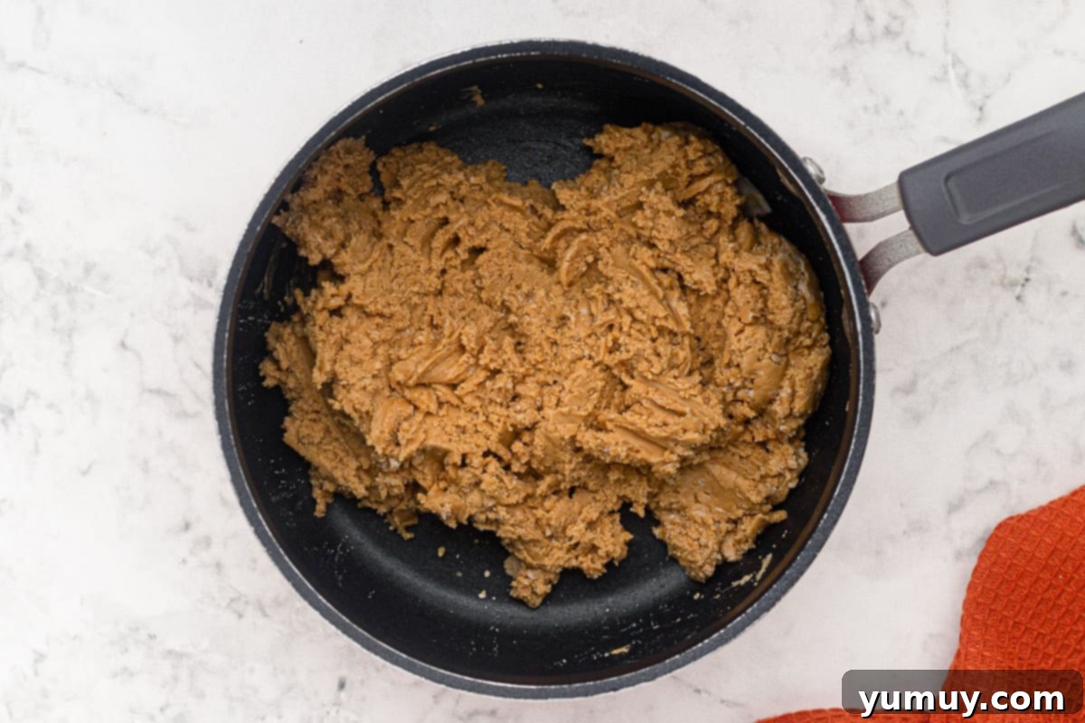 Step 4: Mixing peanut butter, butter, powdered sugar, and vanilla in a saucepan for the filling.