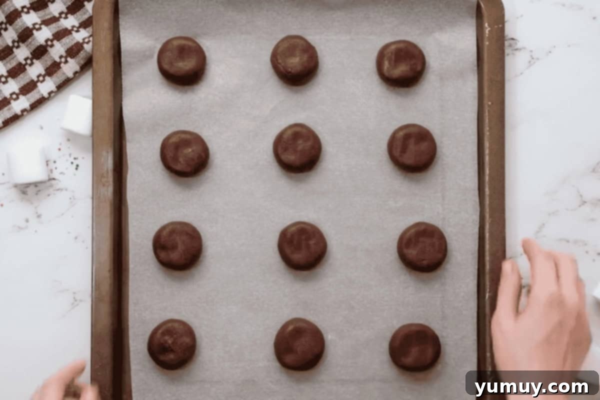 portioned hot chocolate cookies on a baking sheet before baking.