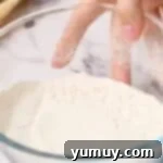 A bowl of cooled, sifted, heat-treated flour, prepared and ready to be used in various recipes or stored.