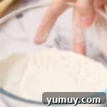 A bowl of cooled, heat-treated flour, sifted and ready for use in no-bake desserts.