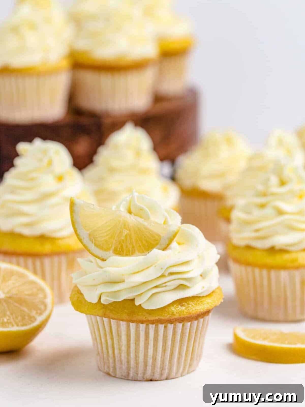 lemon cupcakes topped with lemon whipped cream frosting