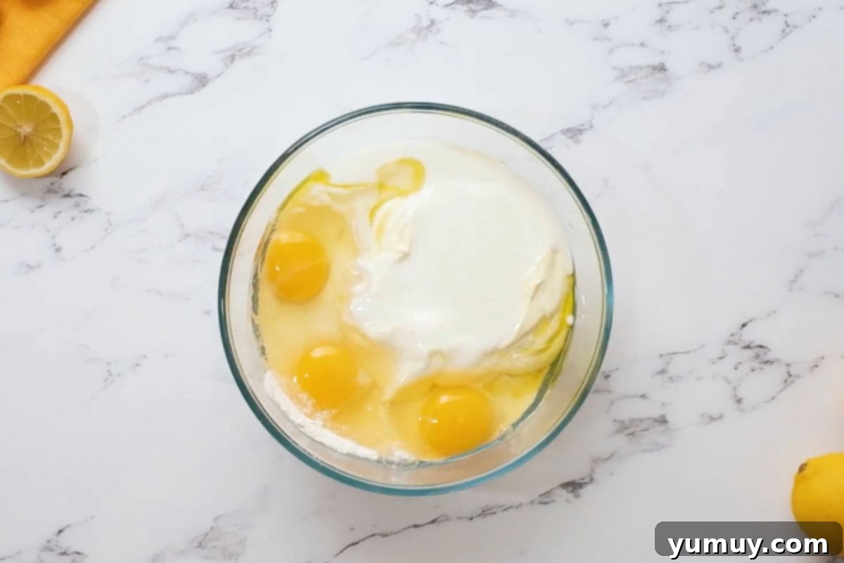 ingredients for lemon cupcakes in a glass bowl.