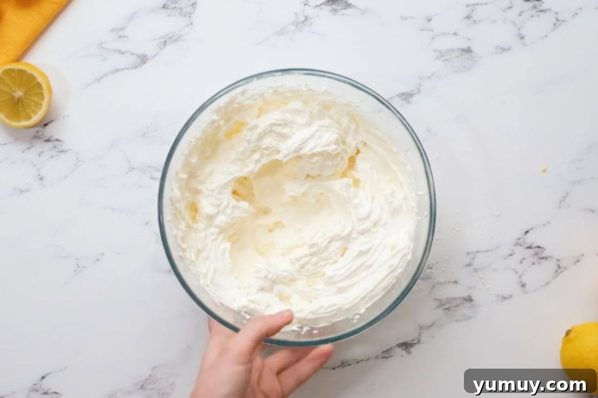 lemon whipped cream frosting in a glass bowl.
