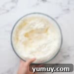 lemon whipped cream frosting in a glass bowl.