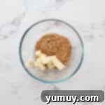 Instant Monkey Bread Delight 6 Cubes of unsalted butter and brown sugar measured into a glass bowl, ready for melting.
