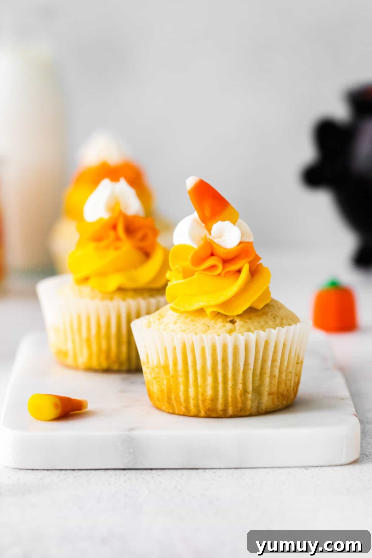 up close candy corn cupcakes on marble tray