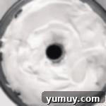 Lemon angel food cake batter evenly spread in an ungreased tube cake pan.