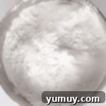 Sifted cake flour and powdered sugar in a bowl, ready to be added to the meringue.