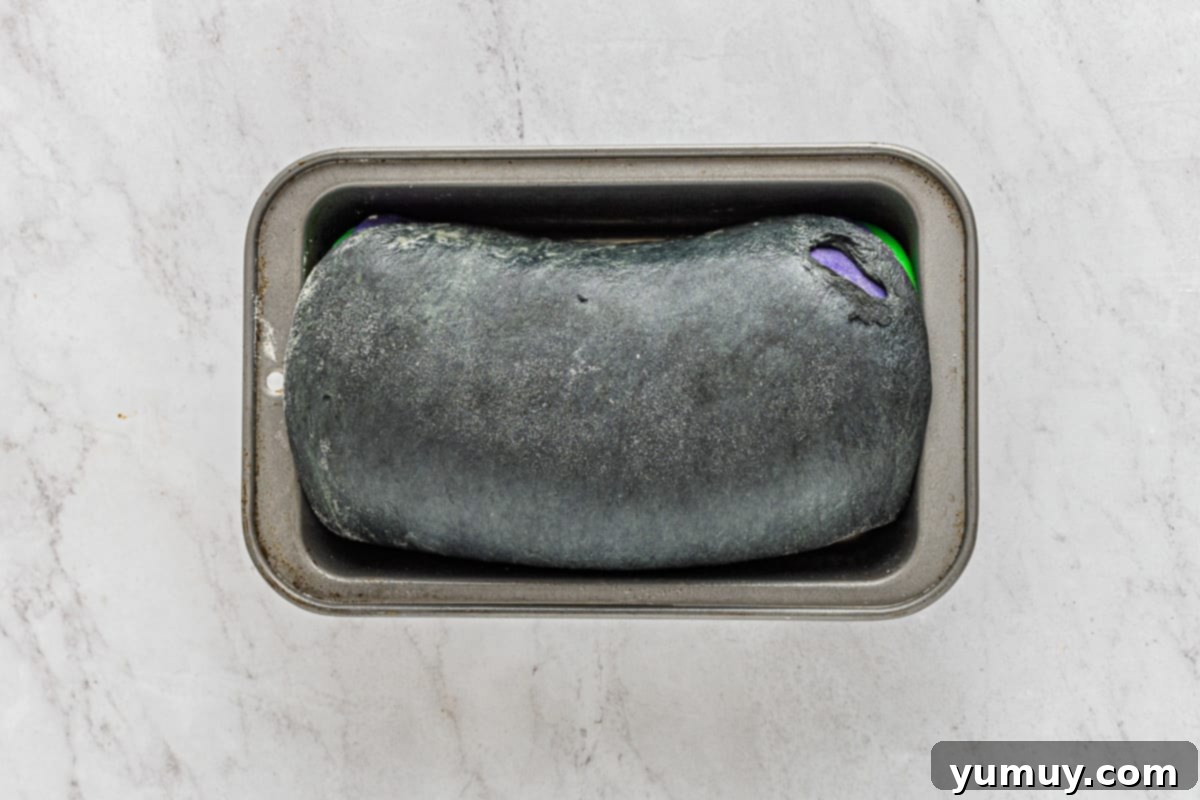 Enchanted Halloween Loaves 22 Unbaked loaf of spooky bread in a loaf pan.