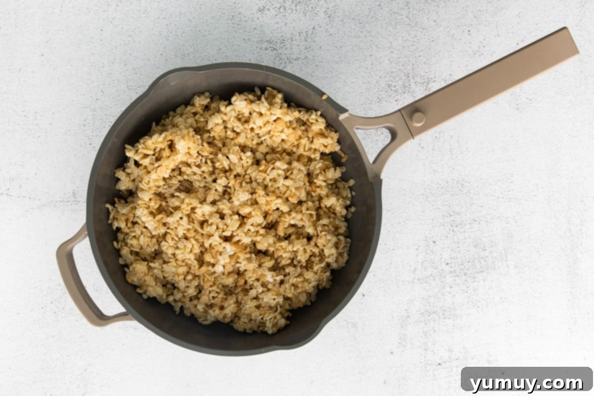 Spooky Crispy Halloween Squares 12 Rie Krispies cereal combined with marshmallow in a pot.