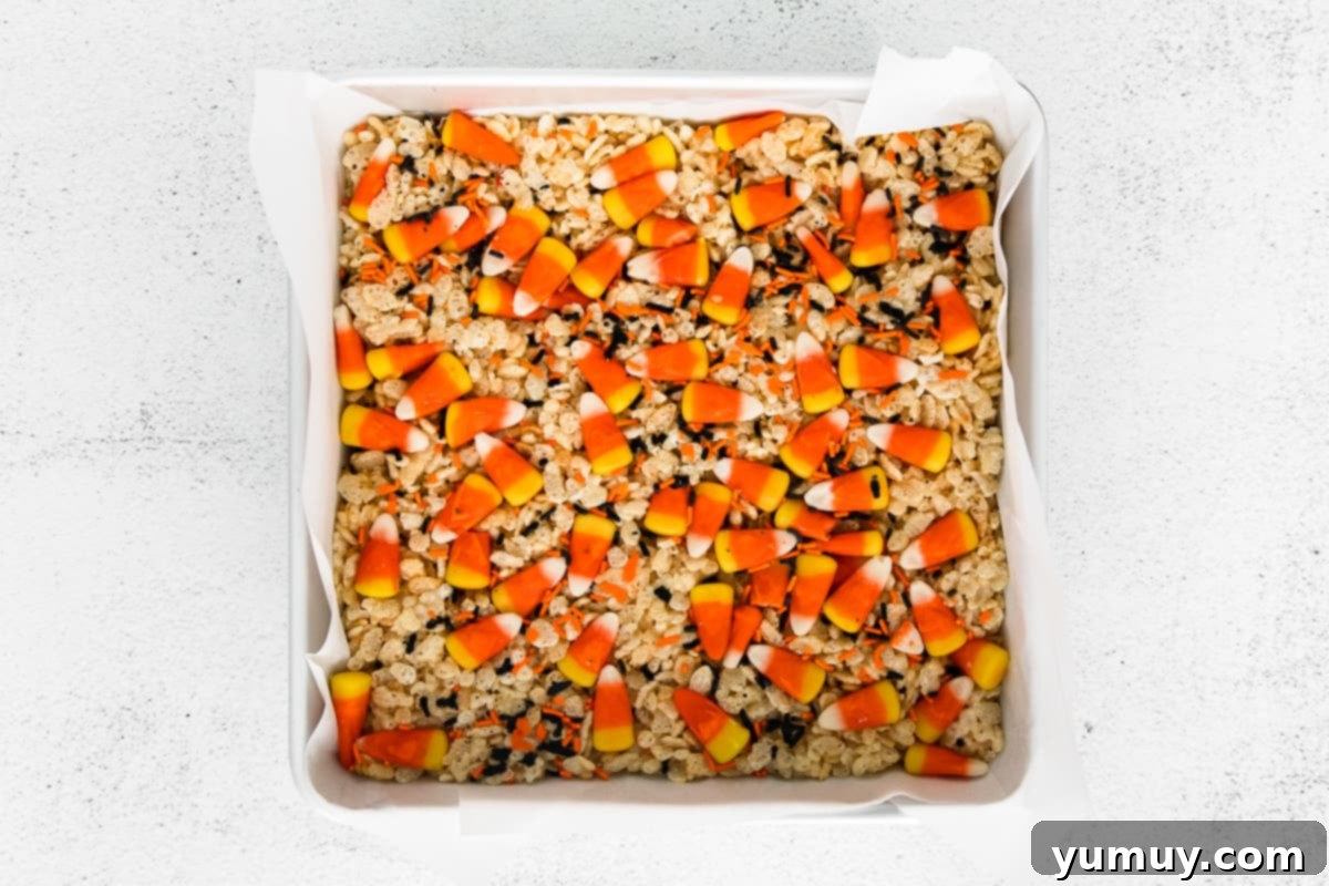 Spooky Crispy Halloween Squares 13 A baking pan of Rice Krispie treats with candy corn.