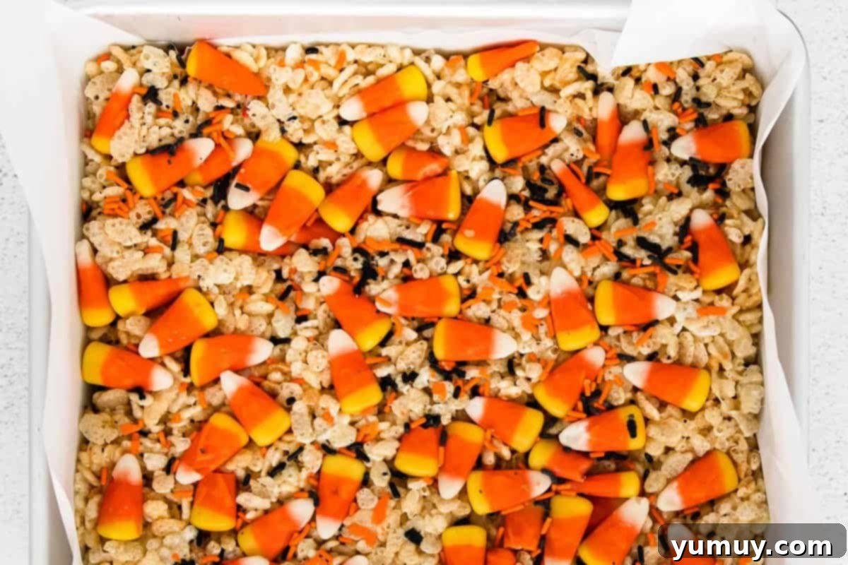 Spooky Crispy Halloween Squares 3 A sheet of Rice Krispie treats filled with candy corn.