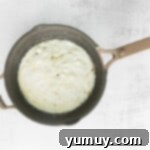 Spooky Crispy Halloween Squares 6 Marshmallow melting in a pot.