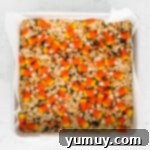 Spooky Crispy Halloween Squares 8 A baking pan of Rice Krispie treats with candy corn.