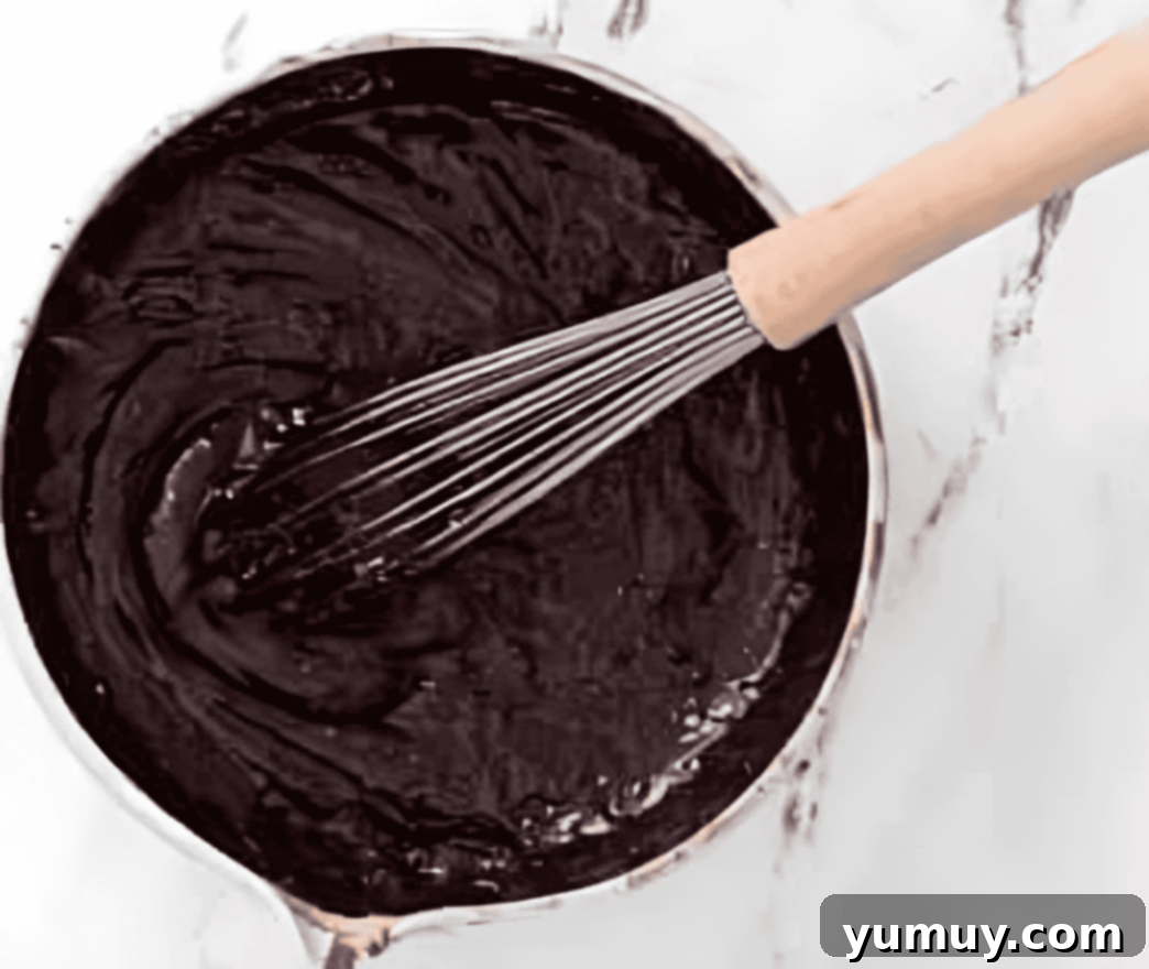 chocolate cupcake batter in a mixing bowl with a whisk.