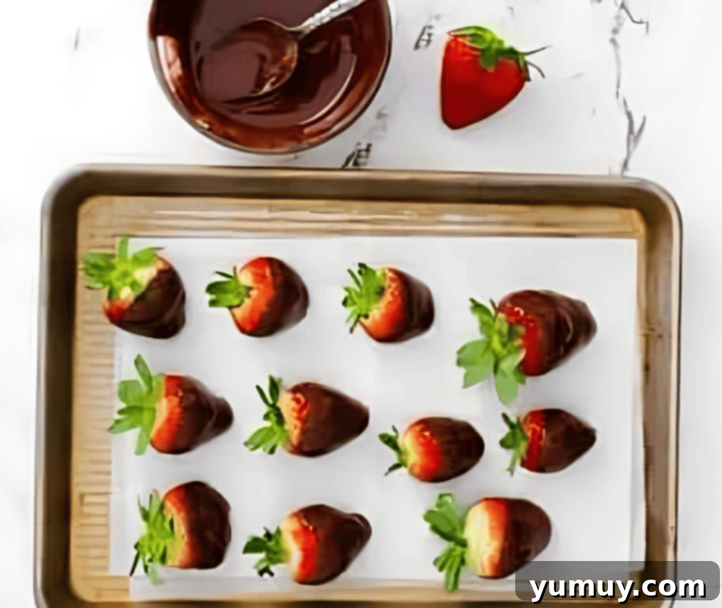 chocolate dipped strawberries on a baking sheet.