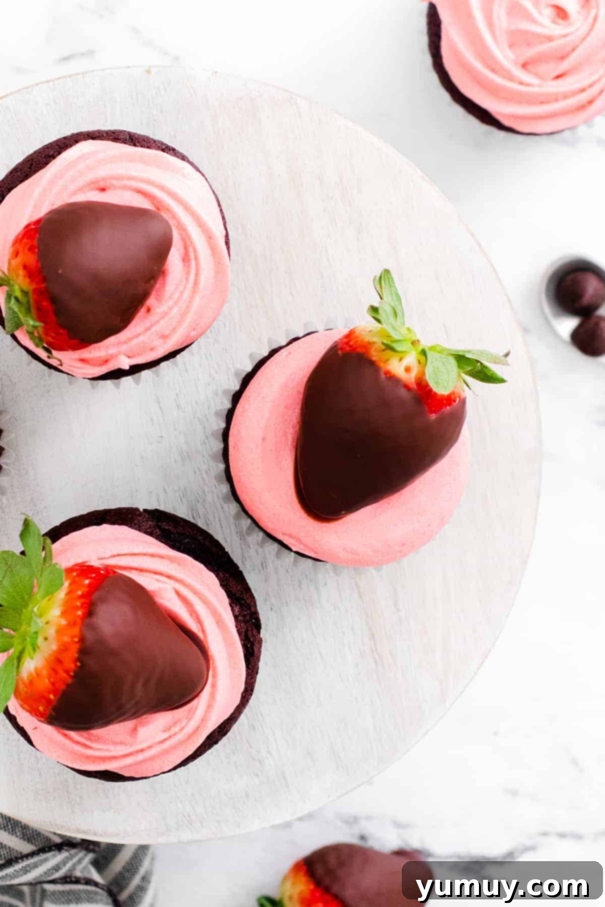 overhead image of chocolate covered strawberry cupcakes on cake stand
