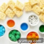 Unwrapped Rice Krispie treats ready for dipping, ingredients laid out for making Halloween monster treats.