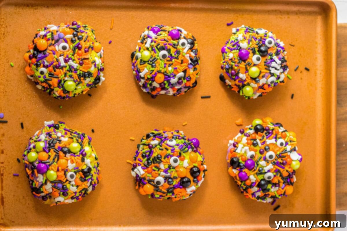 Freshly baked Halloween sprinkle cookies, richly coated in candies.