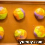 Marbled cookie dough balls ready for sprinkles.