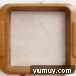 Baking pan meticulously lined with parchment paper, ready for the shortbread crust.