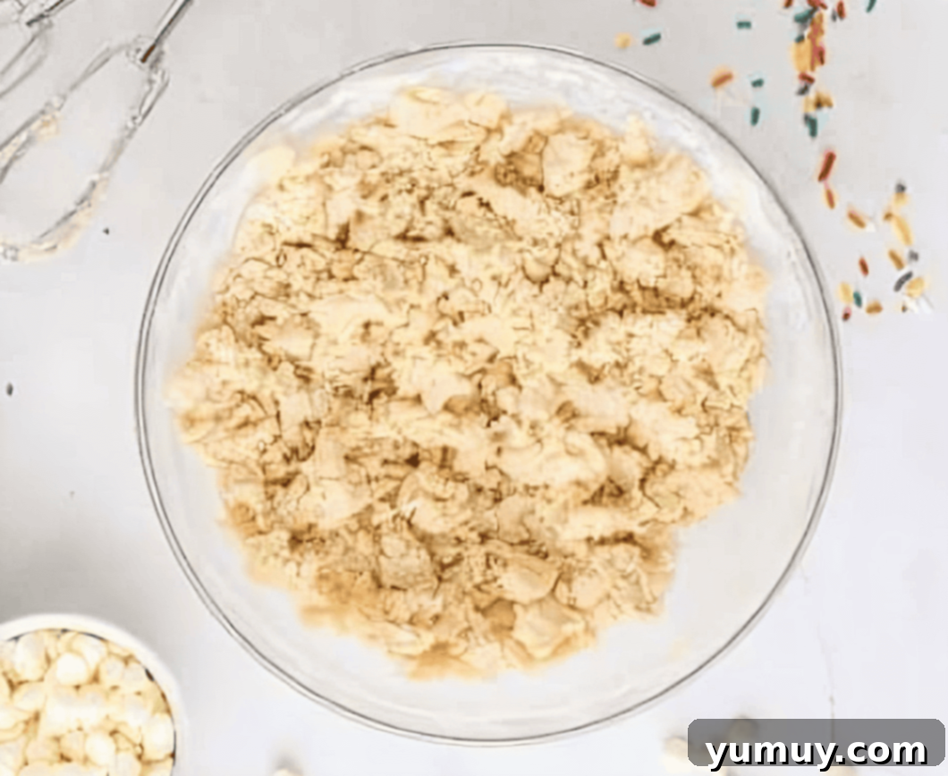 crumbly cookie dough in a glass bowl.