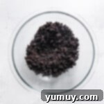 Mixing Oreo crumbs and melted butter for the crust