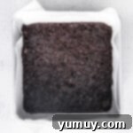 Baked Oreo crust cooling on a wire rack