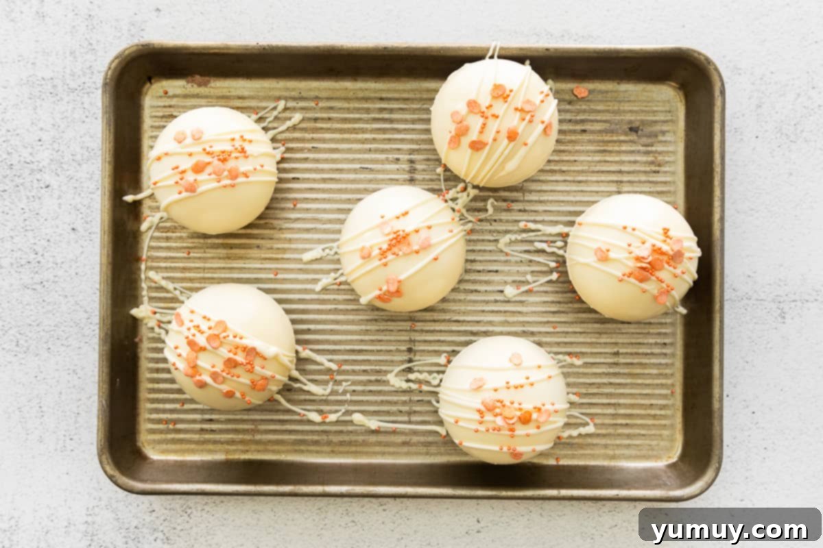 Finished pumpkin hot cocoa bombs, garnished and ready to be enjoyed.