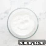 Whipped cream in a glass bowl.