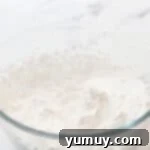 Sweetened whipped cream in a glass bowl.