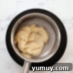 Thick pastry dough in a saucepan after stirring.