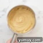 Choux pastry dough in a saucepan after stirring and cooking.