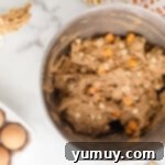 Cookie dough with white chocolate chips and pumpkin spice chips folded in, ready for scooping.