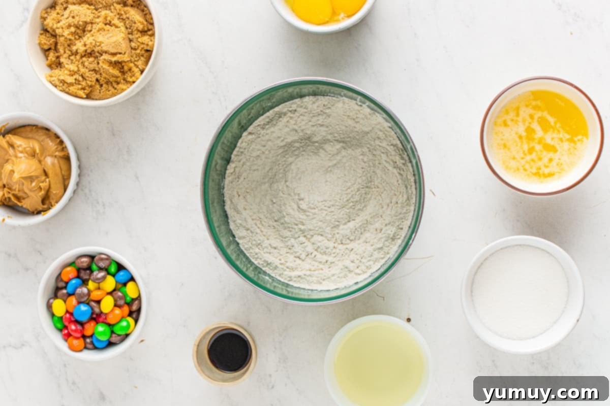 Peanut Butter M&M Blondie Bliss 5 A medium mixing bowl containing flour and baking soda being whisked together, showing the dry ingredients.